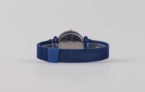 Detail view of starry sky watch with blue mesh band and rose gold adjustment crown