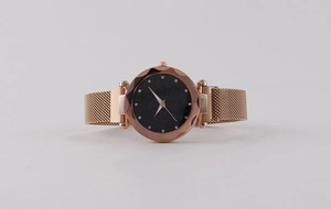 Detailed view of faceted glass crystal and starry sky dial on rose gold watch
