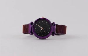 Detail of purple starry sky watch face with faceted glass and magnetic mesh band