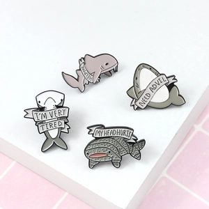 Set of four cute shark enamel pins with humorous slogans on a modern pink grid background