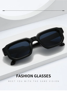 Close-up of black thick-frame rectangular sunglasses with glossy finish and dark lenses