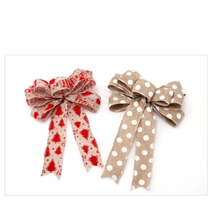 Detail of red Christmas burlap bows with white dots and holiday tree prints