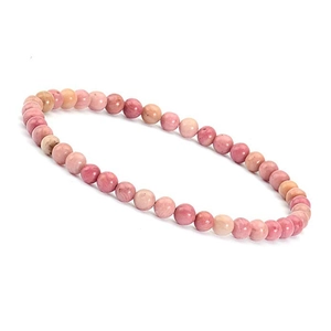 Detailed view of 4mm pink natural stone beads on a stretch bracelet with stone texture
