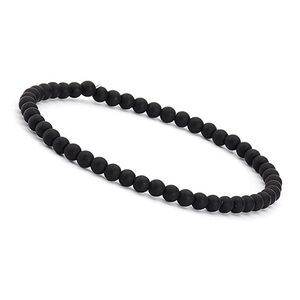 Macro detail of 4mm matte black agate stone beads on a minimalist elastic bracelet
