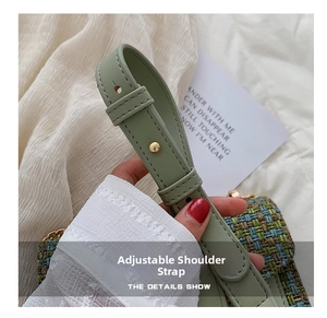 Detail of adjustable sage green leather strap on tweed chain bag with gold metal buckle