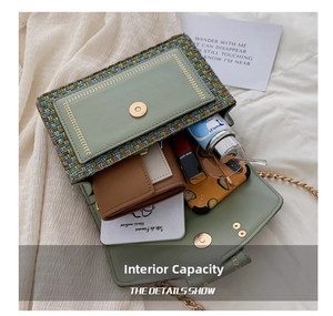 Interior view of green tweed chain bag showing space for wallet and cosmetics