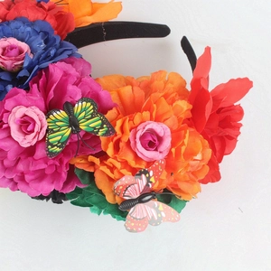 Close-up of Mexican style floral headband with colorful roses and decorative butterflies