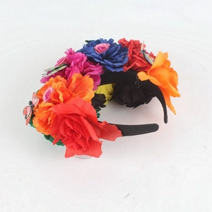 Detail of Mexican floral headband with colorful roses and small butterfly ornaments