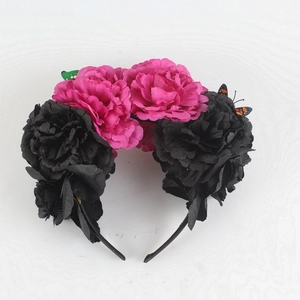 Close-up of Mexican style headband with pink silk peonies and butterfly accents