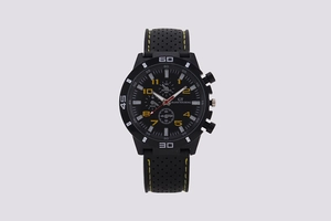 Macro detail of black sports watch with yellow stitching and triple sub-dial interface
