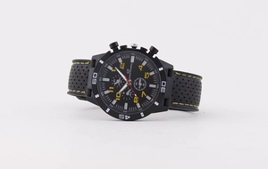 Detail of black sports watch with yellow Arabic numerals and breathable silicone strap