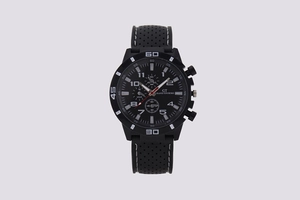 Close-up of GT Grand Touring sports watch with black perforated silicone strap and numbered dial