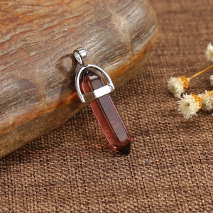 Purple amethyst crystal hexagonal prism pendant with silver clasp on rustic burlap