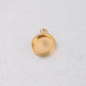 Macro shot of a golden stainless steel round pendant tray with concentric texture