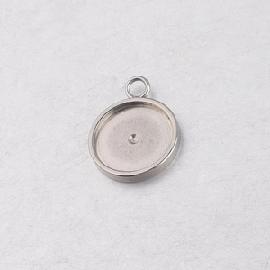 Macro shot of silver stainless steel round pendant tray for DIY jewelry making