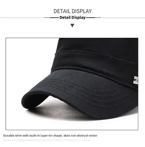 Detail view of stitched brim on black cotton cadet cap with metallic side ornament