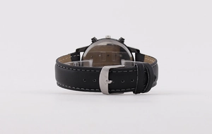Detail of men's quartz watch showing black leather strap with white stitching and metal buckle