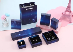Detailed set of dark blue starry nebula jewelry gift boxes and matching paper bags