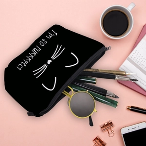 Schwarze Kosmetiktasche aus Canvas mit Katzenprint und Schreibwaren auf Rosa