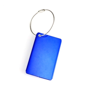 Close-up of blue brushed metal luggage tag with durable stainless steel cable loop