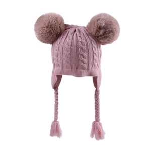 Pink knit baby hat with dual faux fur pom-poms and braided earflaps for winter warmth