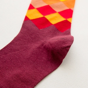 Close-up of diamond pattern knit socks showing fine texture and heel stitching detail