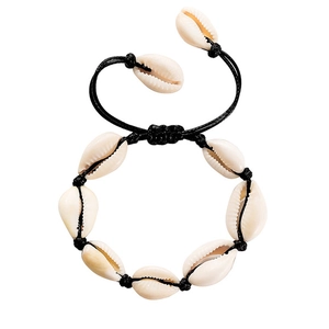 Detail of bohemian shell bracelet with ivory natural shells and black woven wax cord
