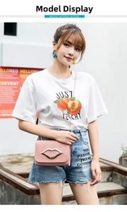 Chic pink leather crossbody bag with golden lip-shaped clasp shown on a model