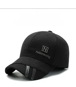 Detail view of winter baseball cap with ear flaps and side logo embroidery