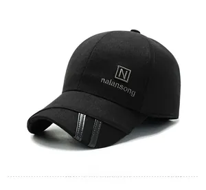 Detailed view of gray letter embroidery and striped brim on a black wool baseball cap