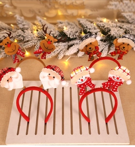 Detail of Christmas headbands set with Santa, Reindeer and Snowman on a festive stand