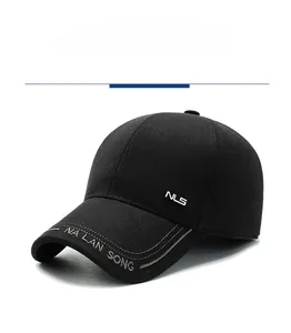 Detail showing NLS metal logo and artistic embroidery on black wool baseball cap