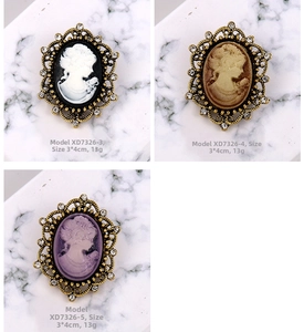 Three vintage lady cameo brooches with rhinestones in black, brown, and purple hues