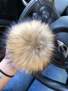 Large natural raccoon fur pompom in tan with dark tips for hats and accessories