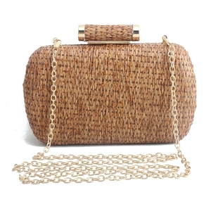 Handmade woven straw clutch bag with gold metal clasp and chain strap for summer