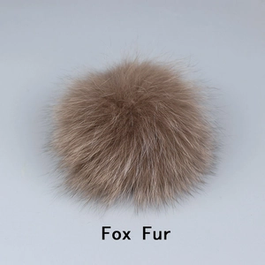 Detail showing the fluffy texture of a natural brown fox fur pompom for accessories
