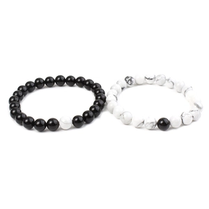 Detail of 8mm matte black agate and white turquoise beaded couple bracelets in yin yang style