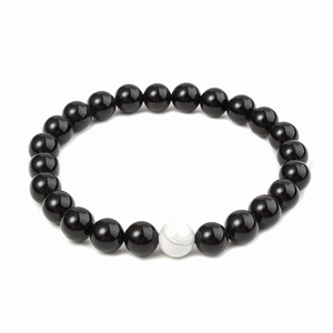 Macro detail of 8mm matte black beads and white marble turquoise on a beaded bracelet