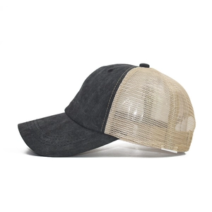 Detail of washed black denim baseball cap with breathable beige mesh panels