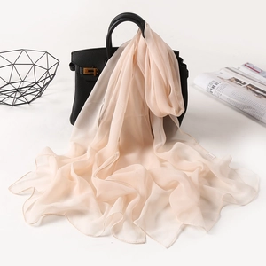 Elegant apricot chiffon scarf draped on a handbag with premium soft aesthetic display