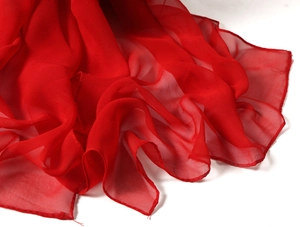 Macro shot of lightweight red chiffon scarf fabric texture with soft silk drapes