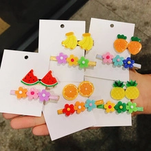 Detailed macro view of colorful resin fruit and flower hair clips for children