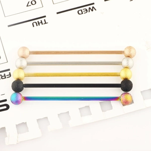 Five industrial barbell earrings in multi-color finishes with matte frosted bead ends