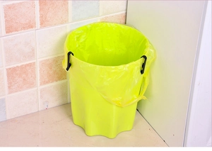 Macro detail of anti-slip trash bin base with plastic clips securing the liner bag