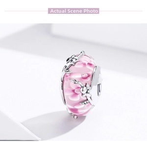 Detail of s925 silver bead with pink floral enamel and sparkling zircon accents