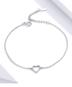 Detailed view of the hollow heart pendant and silver link chain on a white surface