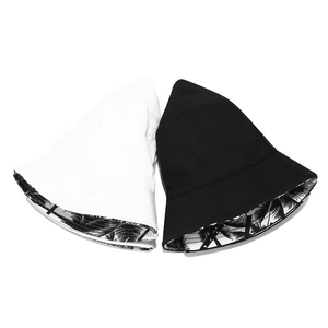 Detail of double-sided bucket hat featuring black and white palm tree print inside