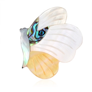 Macro detail of butterfly brooch with white shell wings and colorful abalone body inlay