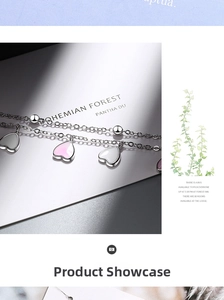 Macro shot of double-layered heart pendants with pink gradient enamel on silver chain