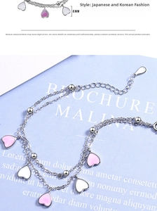 Detail of double-layer silver bracelet with pink heart charm and lobster clasp